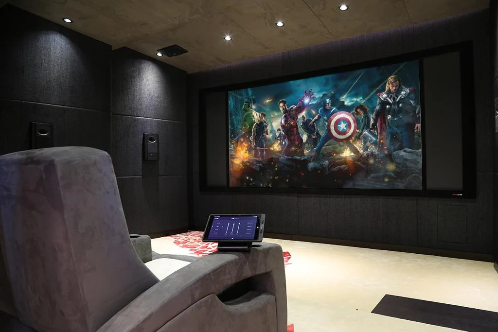 Private home cinema showing projection, acoustic treatment and integrated room control